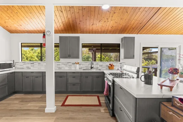 a spacious bathroom with a sink mirror and window