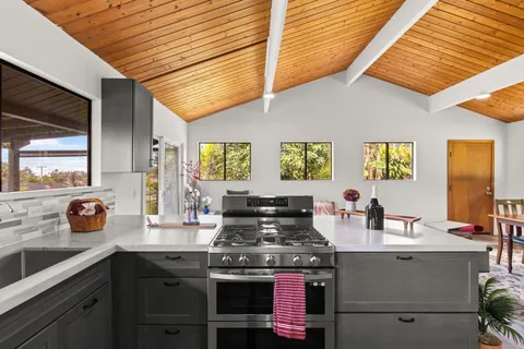 a kitchen with a stove and cabinets