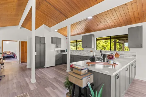 a kitchen with a sink cabinets and wooden floor
