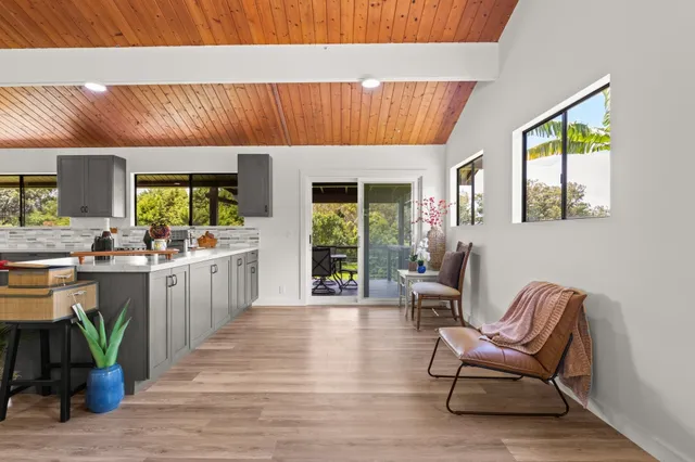 a living room with furniture a window and wooden floor
