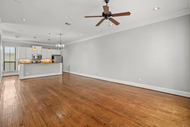 a view of a kitchen with a sink and wooden floor