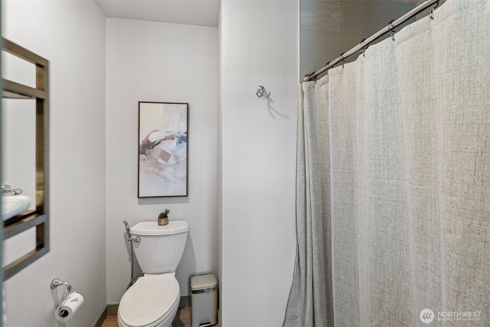 503 5th Street Steilacoom, WA 98388 - Photo 31 of 40 a white toilet sitting next to a shower curtain