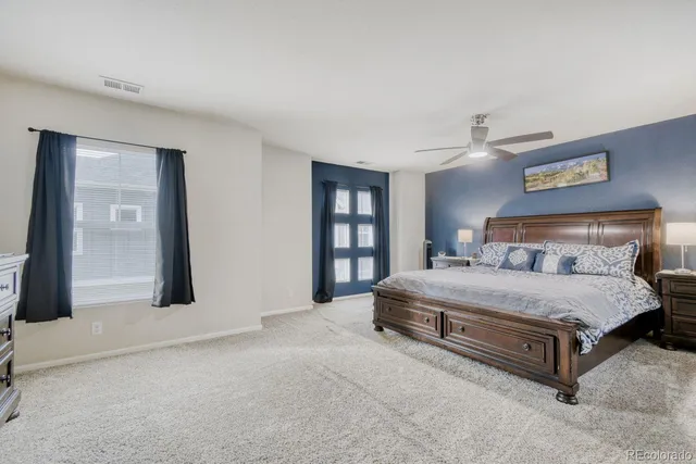 a spacious bedroom with a bed and a large mirror