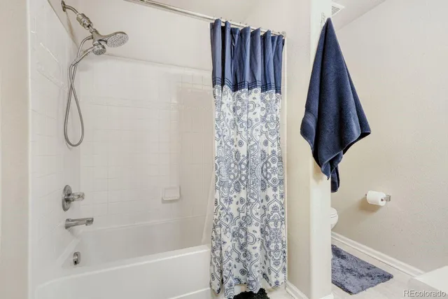 a bathroom with a bathtub and shower