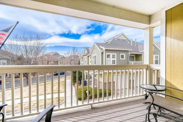 a view of a brick house with a wooden bench and floor