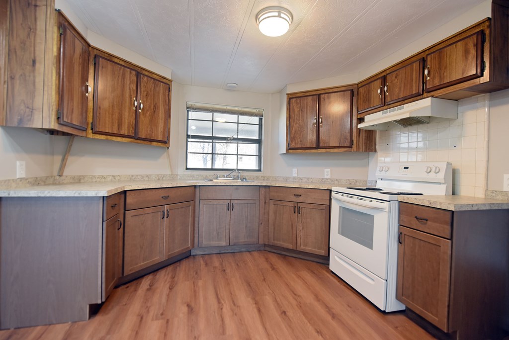 253 Windy Lane Hiawassee, GA 30546 - Photo 19 of 65 a kitchen with stainless steel appliances granite countertop wooden cabinets stove top oven and sink