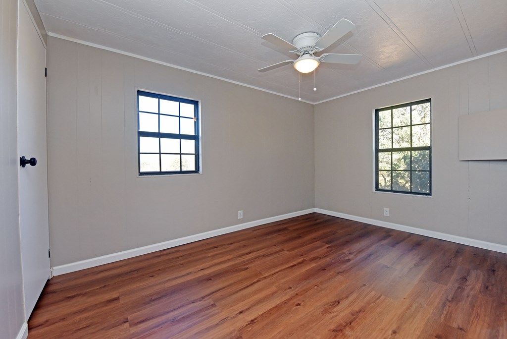 253 Windy Lane Hiawassee, GA 30546 - Photo 30 of 65 an empty room with wooden floor and windows
