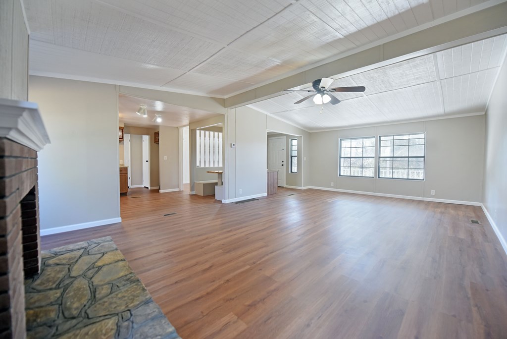 253 Windy Lane Hiawassee, GA 30546 - Photo 36 of 65 a view of an empty room with window and wooden floor