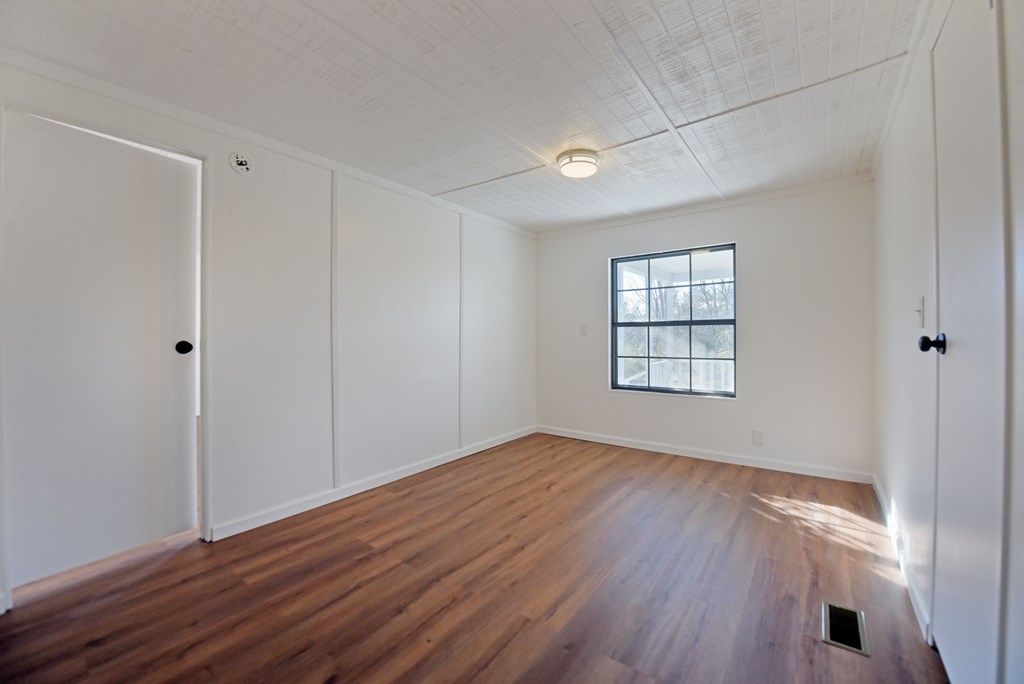 253 Windy Lane Hiawassee, GA 30546 - Photo 38 of 65 a view of an empty room with wooden floor and a window