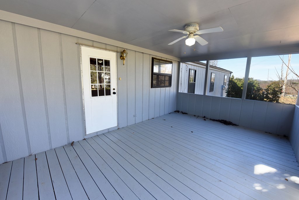 253 Windy Lane Hiawassee, GA 30546 - Photo 4 of 65 a view of an empty room with wooden floor and a window