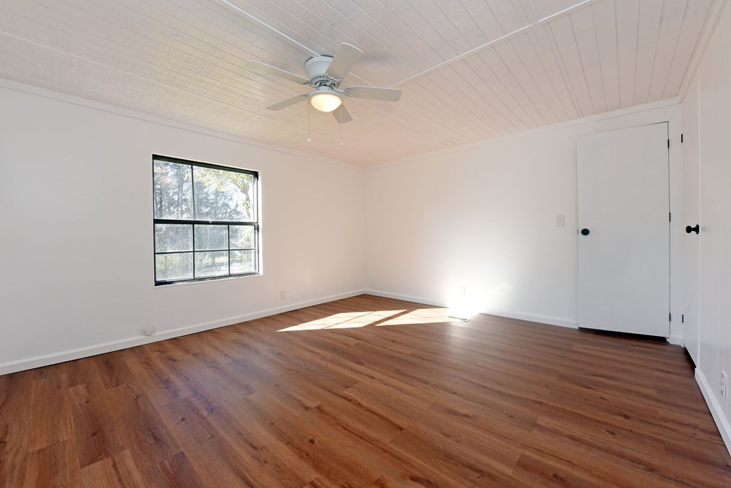 253 Windy Lane Hiawassee, GA 30546 - Photo 45 of 65 an empty room with wooden floor and windows