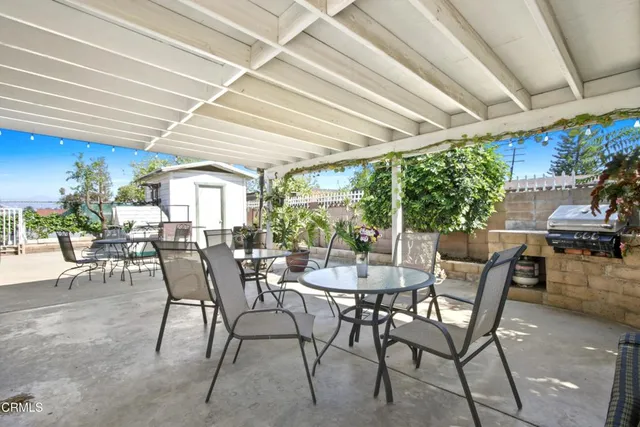 a view of a patio with table and chairs and potted plants