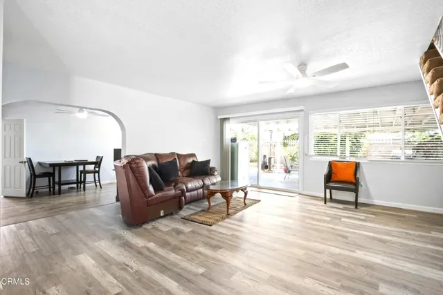 a living room with furniture and a floor to ceiling window