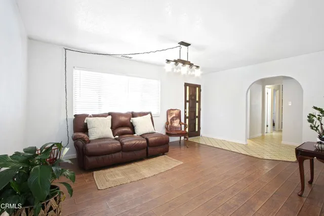 a living room with furniture and a chandelier