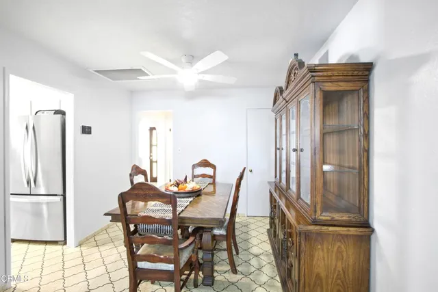 a dining room with furniture and a window