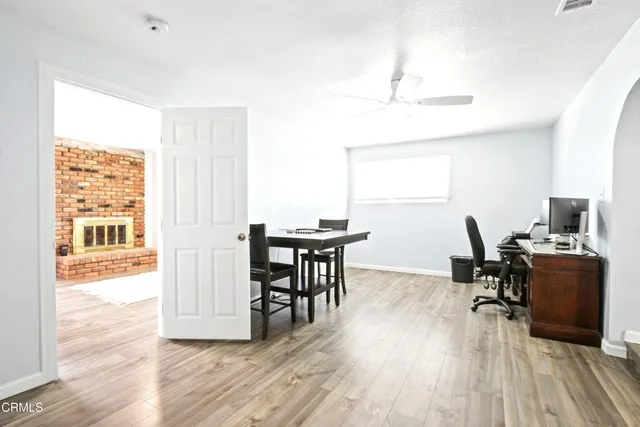 a view of a workspace with furniture and a window