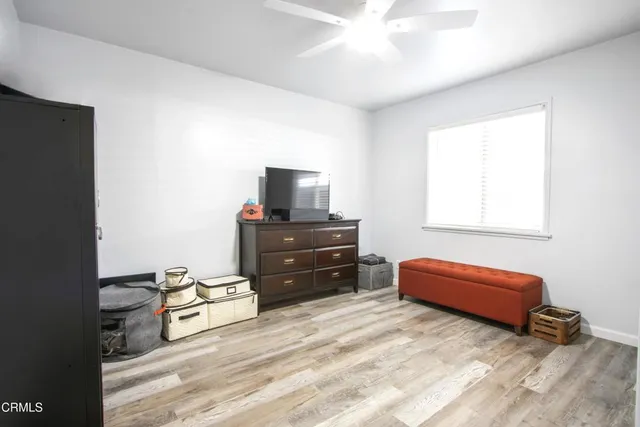 a bedroom with a bed and a television