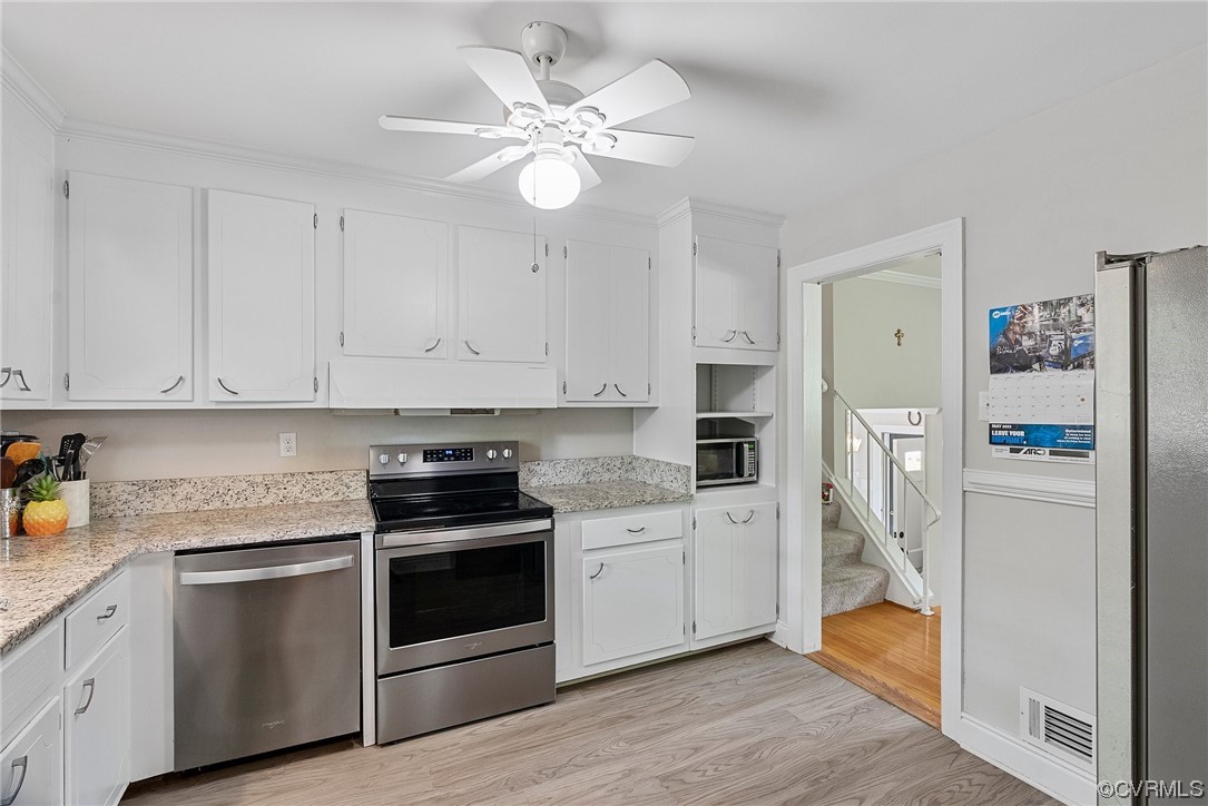 5038 Grassmere Road Richmond, VA 23234 - Photo 24 of 50 a kitchen with stainless steel appliances a stove a sink and white cabinets