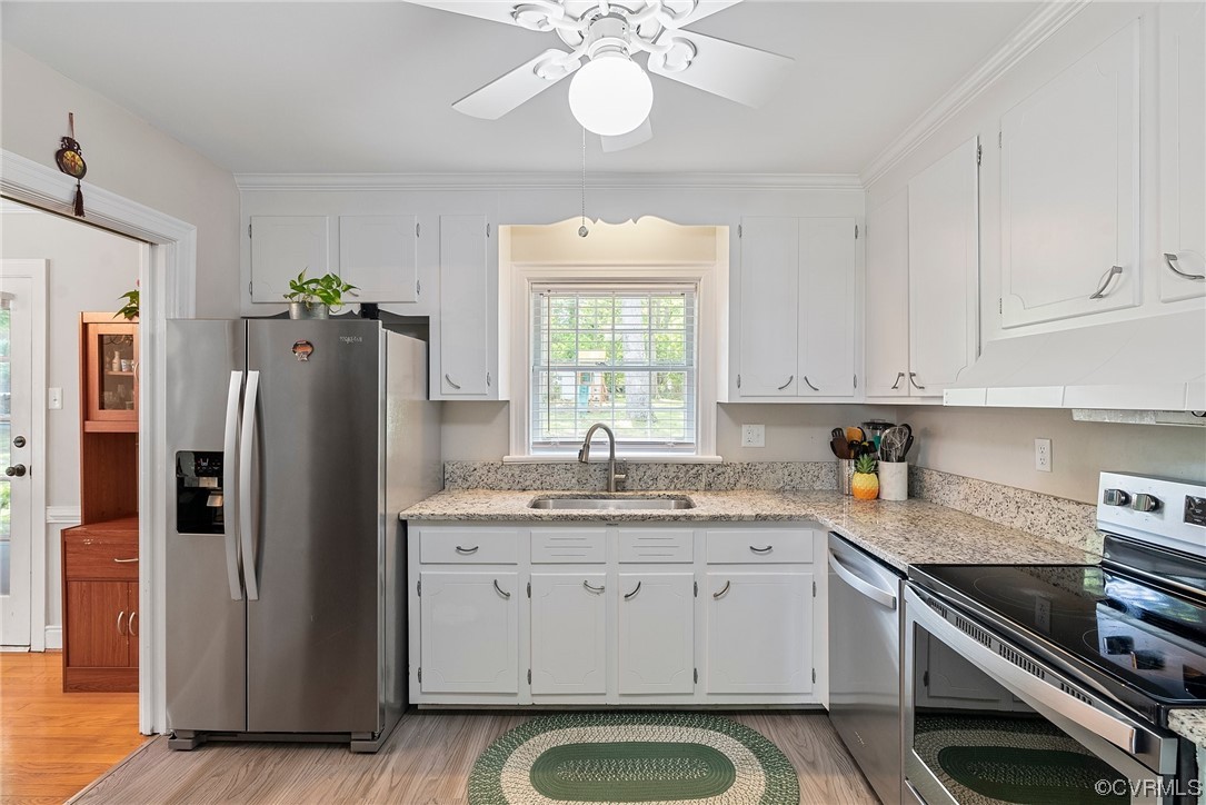 5038 Grassmere Road Richmond, VA 23234 - Photo 25 of 50 a kitchen with a refrigerator and a sink
