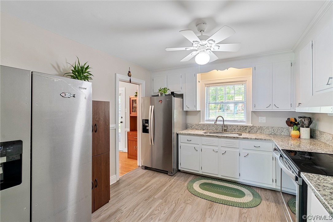 5038 Grassmere Road Richmond, VA 23234 - Photo 26 of 50 a kitchen with a refrigerator a sink and cabinets