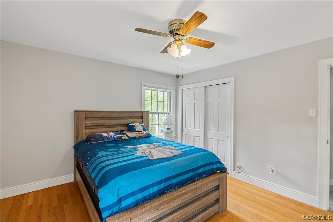 5038 Grassmere Road Richmond, VA 23234 - Photo 36 of 50 a bedroom with a bed and a chandelier
