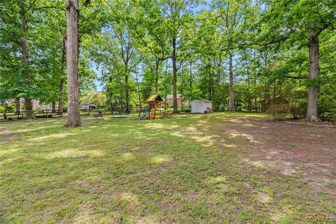 5038 Grassmere Road Richmond, VA 23234 - Photo 49 of 50 a view of a field with trees in the background