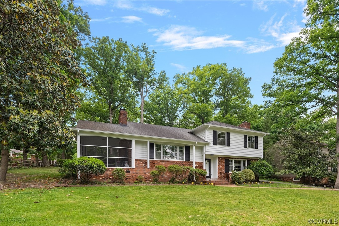 5038 Grassmere Road Richmond, VA 23234 - Photo 5 of 50 a front view of a house with garden and trees