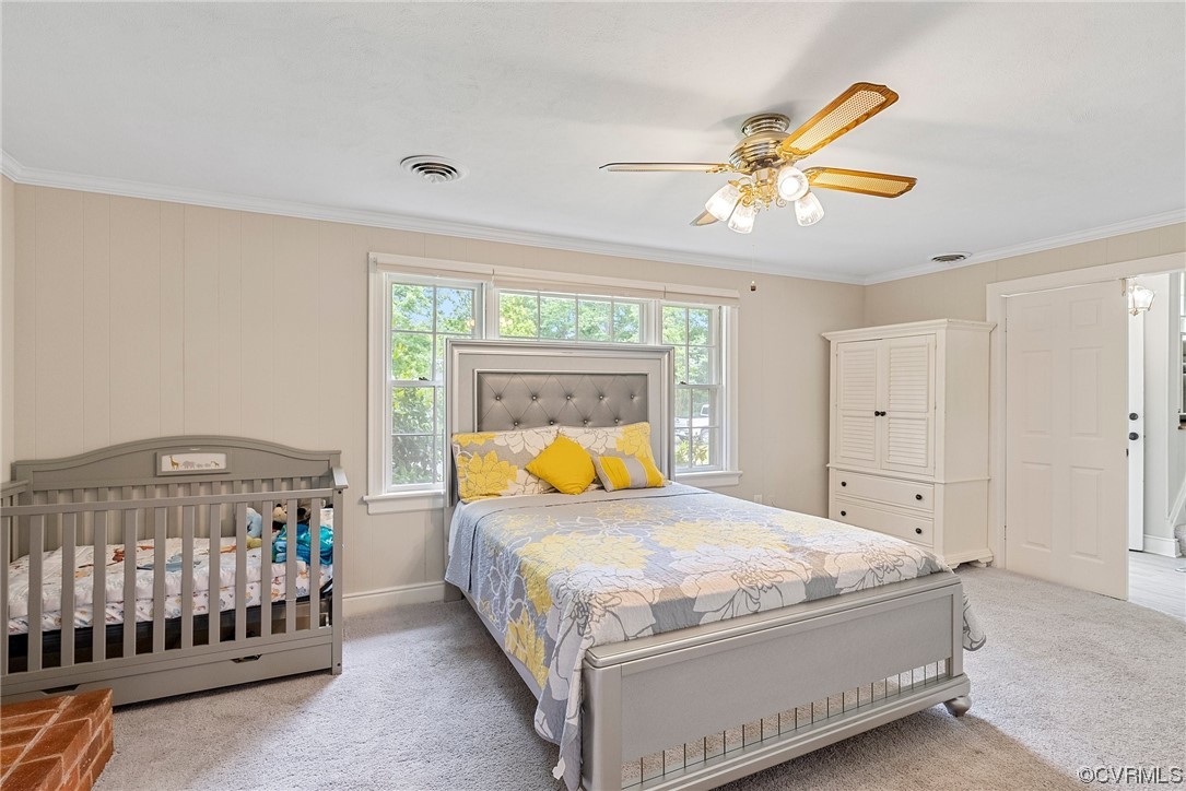 5038 Grassmere Road Richmond, VA 23234 - Photo 10 of 50 a bedroom with a bed and a chandelier