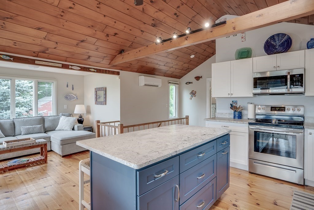 7 Brooks Road Gloucester, MA 01930 - Photo 22 of 33 a living room with furniture and a flat screen tv