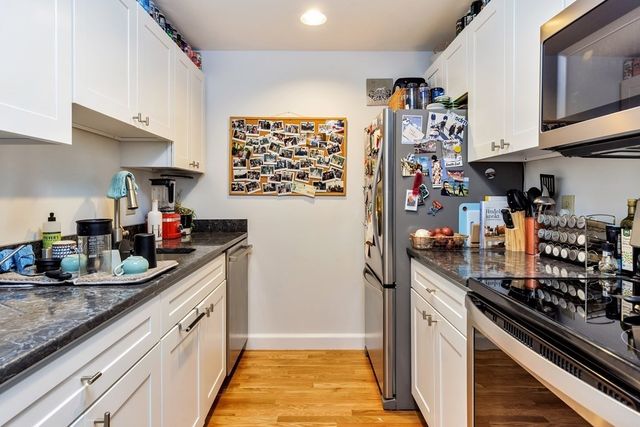a kitchen with refrigerator and cabinets