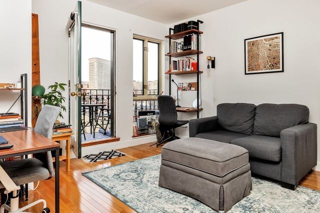 a living room with furniture next to a window