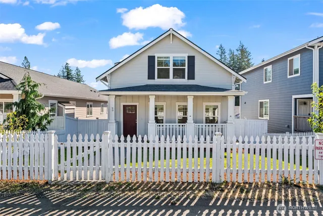 a front view of a house with a fence