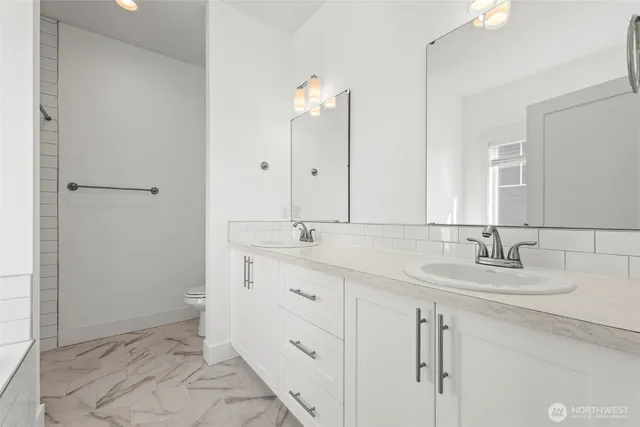 a bathroom with a double vanity sink and mirror