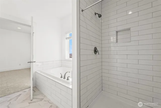 a bathroom with a bathtub and shower
