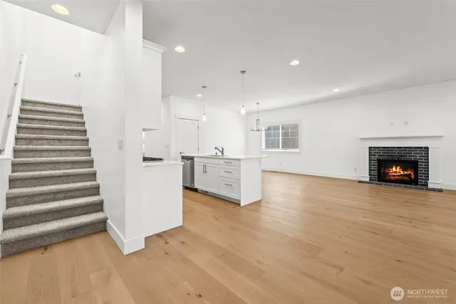 a view of a kitchen with a sink and a fireplace