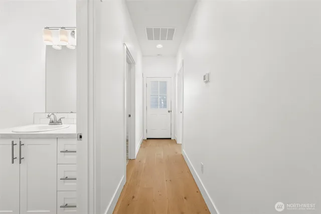 a view of a hallway with wooden floor