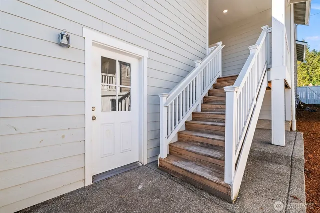 a view of entryway with wooden floor and stairs