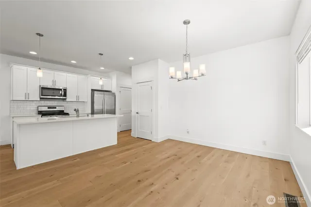 a view of a kitchen with microwave and cabinets