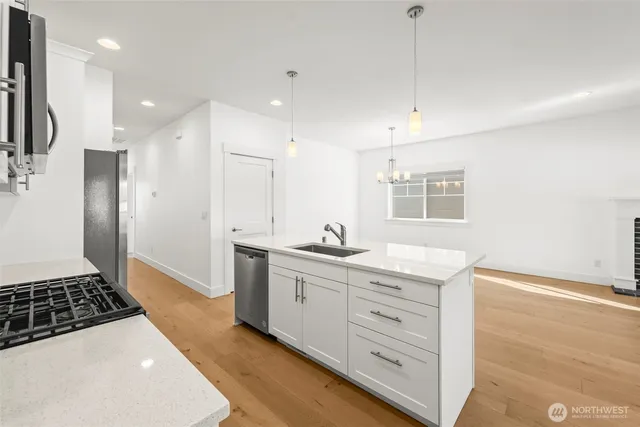 a kitchen with a sink a counter space and appliances