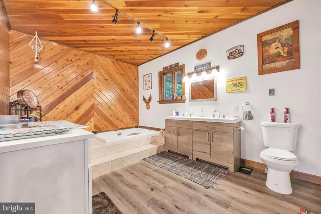 a view of a walk in closet with wooden floor