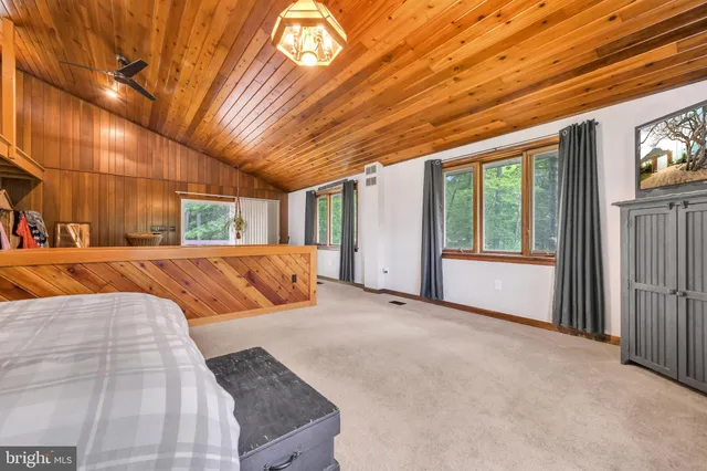 a bathroom with a sink vanity mirror and toilet