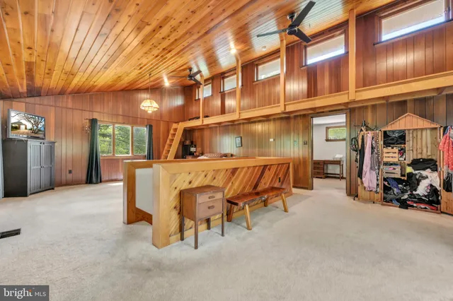 a view of a walk in closet with wooden floor