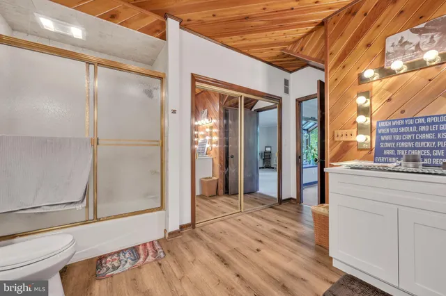 a bathroom with a sink a toilet and mirror