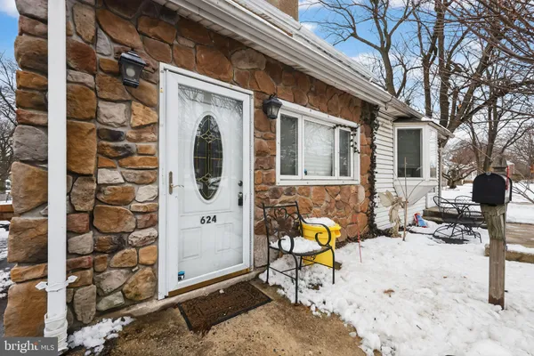 a building outdoor space with patio furniture and potted plants