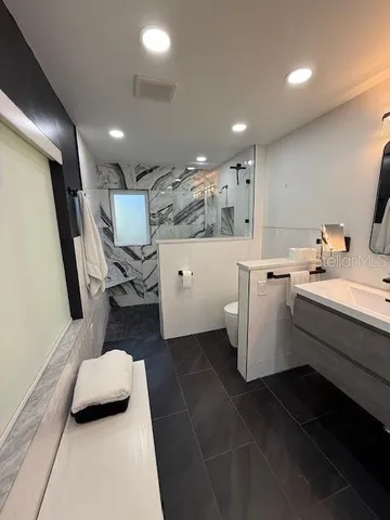 a bathroom with a sink a toilet and a mirror