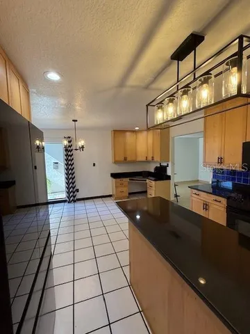 a kitchen with stainless steel appliances a refrigerator and a stove top oven