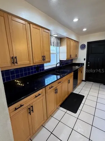 a utility room with sink dryer and washer