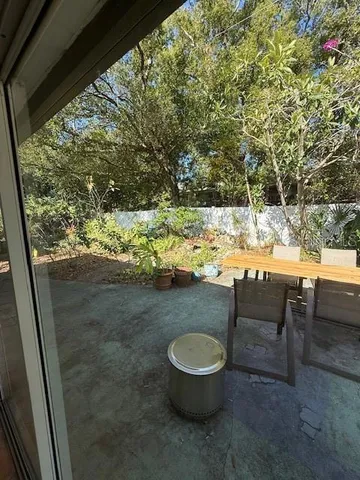 a room with lots of furniture and a large window