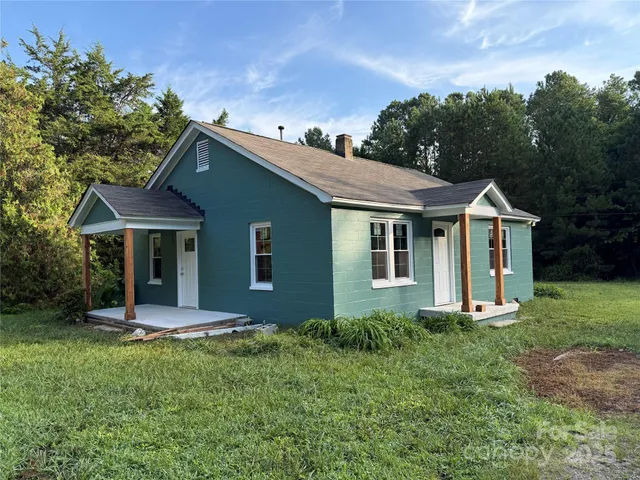 a front view of house with a garden