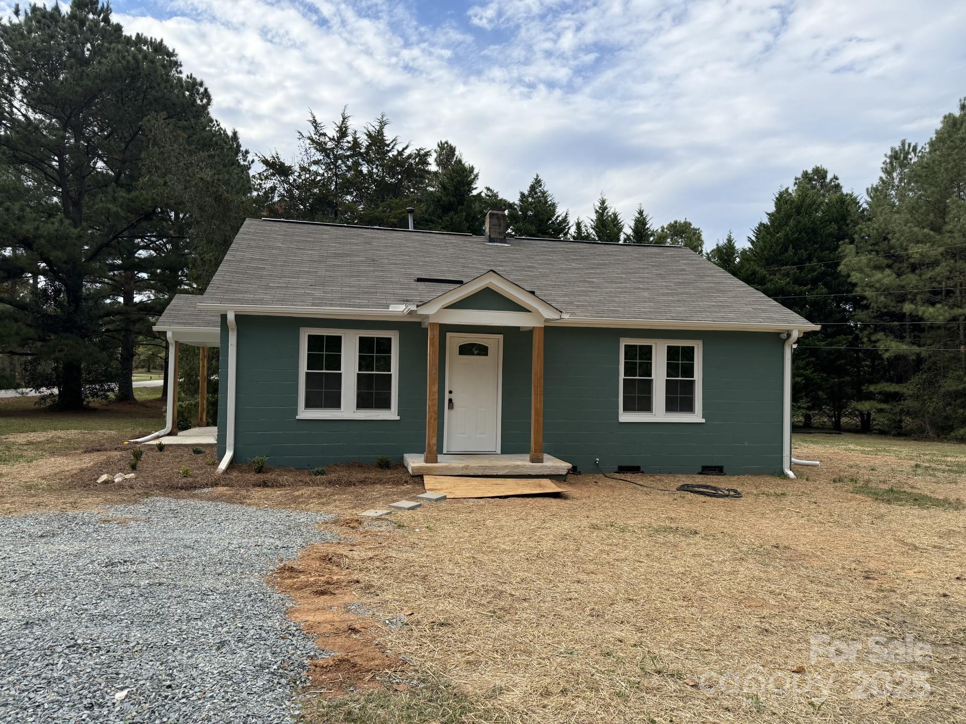 2791 State Rd S-29-285 Lancaster, SC 29720 - Photo 3 of 15 a house with glass top table and chairs under an umbrella